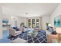 Bright living room featuring matching furniture, large window, and stylish blue accents at 56 Bay Woods Dr, Safety Harbor, FL 34695