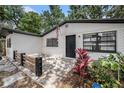 Close up of the home's front door with black trim and a small front patio area at 5801 92Nd N Ave, Pinellas Park, FL 33782