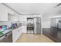 Updated kitchen with stainless steel appliances, granite countertops and white cabinetry at 5801 92Nd N Ave, Pinellas Park, FL 33782