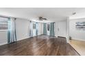 Bright living room features hardwood floors, ceiling fan, and plenty of natural light at 5801 92Nd N Ave, Pinellas Park, FL 33782