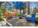 Cozy outdoor living space with colorful seating, a fire pit, and views of the surrounding waterway at 7300 Mackerel Ln, Hudson, FL 34667