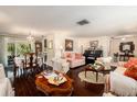 Spacious living area with hardwood floors, view to the dining area and comfortable seating arrangements at 8105 Valley Stream Ln, Hudson, FL 34667
