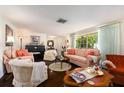 Bright living room featuring hardwood floors, natural lighting from the windows, and stylish furniture at 8105 Valley Stream Ln, Hudson, FL 34667