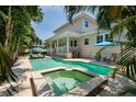 Inviting backyard oasis featuring a refreshing pool, hot tub, and patio with comfortable seating at 852 Cordova Ne Blvd, St Petersburg, FL 33704