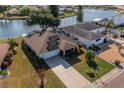 Aerial view of single-Gathering home with solar panels, manicured lawn, and access to a waterway at 913 El Rancho Dr, Sun City Center, FL 33573