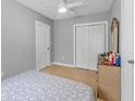 Cozy bedroom with neutral walls, tile flooring, ceiling fan, closet, and dresser at 918 E 24Th Ave, Tampa, FL 33605