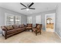 Inviting living room features neutral walls, tile flooring, ceiling fan and traditional-style furniture at 918 E 24Th Ave, Tampa, FL 33605