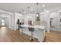Bright and modern kitchen with stainless steel appliances, large island, and sleek countertops at 9271 Rally Spring Loop, Wesley Chapel, FL 33545