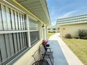 Condo exterior featuring an outdoor seating area and view of adjacent units at 102 Cambridge Trl # 230, Sun City Center, FL 33573