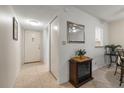 Hallway that leads to the living room showcases tile flooring, fresh paint, and ample storage at 11485 Oakhurst Rd # 200-101, Largo, FL 33774