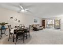 Spacious living room features neutral carpeting, ceiling fan, and ample natural light at 11485 Oakhurst Rd # 200-101, Largo, FL 33774