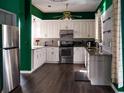 Modern kitchen with stainless steel appliances, granite countertops, and ample cabinet space at 1204 Rinkfield Pl, Brandon, FL 33511