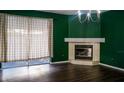 Cozy living room featuring a fireplace and dark wood flooring at 1204 Rinkfield Pl, Brandon, FL 33511
