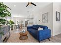 Open-concept living room with hardwood floors, a comfortable blue sofa, and adjacent kitchen and dining area at 121 E Warren Ave # 4, Tampa, FL 33602