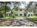 Spacious two-story home featuring a large driveway and black shutters at 12433 Kelso Rd, Thonotosassa, FL 33592