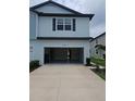 Open garage of a two-story home showing a concrete driveway and ample space at 19643 Shady Oak Dr, Land O Lakes, FL 34638