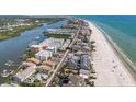Stunning aerial view of the beachfront property with the beautiful coastline at 19925 Gulf Blvd # 407, Indian Shores, FL 33785