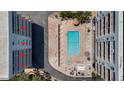 Aerial view of pool and amenities, nestled between beachfront condo buildings at 19925 Gulf Blvd # 407, Indian Shores, FL 33785
