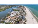 Beautiful aerial view of beachfront condos with pristine white sand, gorgeous blue waters, and coastal living at 19925 Gulf Blvd # 407, Indian Shores, FL 33785
