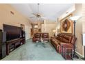 Spacious living room with comfortable leather seating, ceiling fan, and neutral paint at 2024 Glen Forge St, Brandon, FL 33511