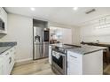 Bright kitchen with stainless steel appliances, granite countertops, and white cabinetry at 205 W 122Nd Ave, Tampa, FL 33612