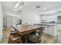 Eat-in kitchen with granite countertops, a large island, and modern light fixture at 205 W 122Nd Ave, Tampa, FL 33612