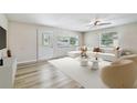 Bright living room featuring wood floors, a modern sectional sofa, and an inviting design at 205 W 122Nd Ave, Tampa, FL 33612