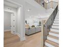 Bright open-concept living room features hardwood floors and a modern staircase at 218 Hesperides N St, Tampa, FL 33609