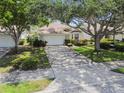 Charming one-story home with a two-car garage, long driveway, mature trees and manicured landscaping at 2216 Evans Rd, Clearwater, FL 33763