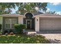 Charming single-story home featuring a well-manicured lawn and a two-car garage at 2617 Heatherwood Dr, Tampa, FL 33618