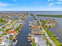 Aerial view of waterfront community featuring canals, boat docks, and beautiful landscaping at 4012 Marine Pkwy, New Port Richey, FL 34652