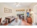 Inviting living room with hardwood floors, a ceiling fan, and natural light showcasing a comfortable ambiance at 404 Laurel Lake Dr # 101, Venice, FL 34292