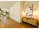 Welcoming foyer with stylish mirror, console table, and hardwood floors at 4103 W Knights Ave, Tampa, FL 33611