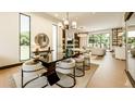 Bright, open-concept living space with modern furnishings and elegant lighting at 4103 W Knights Ave, Tampa, FL 33611