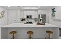 Bright kitchen featuring a large quartz island with seating, stainless steel appliances, and modern finishes at 450 Knights Run Ave # 104, Tampa, FL 33602