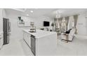 Open-concept living space with a kitchen island and a cozy sitting area with natural light at 450 Knights Run Ave # 104, Tampa, FL 33602