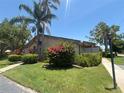 Charming home with a well-maintained lawn, beautiful shrubs, and swaying palm trees at 4558 Morningside # 43, Sarasota, FL 34235