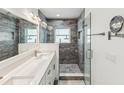 Modern bathroom with glass shower, tiled walls, and double sink vanity at 464 20Th Ave, Indian Rocks Beach, FL 33785