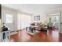Cozy living room showcasing wood floors, natural light, and an easy transition to the dining area at 4701 W Wyoming Ave, Tampa, FL 33616