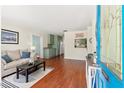 Inviting living room features wood floors, comfortable seating, and an open layout into the kitchen at 4701 W Wyoming Ave, Tampa, FL 33616