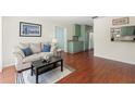 Bright living room with hardwood floors, neutral decor, and a seamless flow to adjacent rooms at 4701 W Wyoming Ave, Tampa, FL 33616