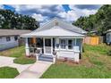 A sunny aerial view of a charming single-story home with a metal roof and well-maintained landscaping at 508 N Walker St, Plant City, FL 33563