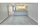 Open-concept living room and kitchen with new gray carpeting at 5303 Terraza Ct, Temple Terrace, FL 33617