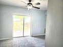 Light and airy living room features a sliding glass door to the outside at 5303 Terraza Ct, Temple Terrace, FL 33617