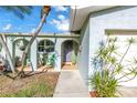 Inviting home entrance with an arched, covered porch, decorative accents, and a well-maintained walkway at 5925 18Th Ne St, St Petersburg, FL 33703