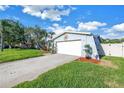 Garage exterior with a double door and mature lawn, featuring a landscaped garden next to the driveway at 5925 18Th Ne St, St Petersburg, FL 33703