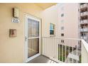 Condo front door entrance with glass window and outdoor balcony at 6075 Shore S Blvd # 215, Gulfport, FL 33707