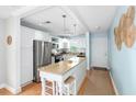 Charming kitchen with granite countertops, stainless appliances, and breakfast bar at 6075 Shore S Blvd # 215, Gulfport, FL 33707