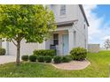 A two-story home featuring a light blue front door, manicured landscaping, and green lawn at 6180 Spring Crayfish Ave, New Port Richey, FL 34653
