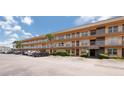 Spacious Willow Lake condo complex exterior showcasing ample parking and well-maintained landscaping at 6400 46Th N Ave # 203, Kenneth City, FL 33709